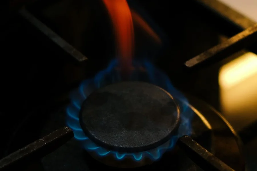 gas burner blue flame stove top close up