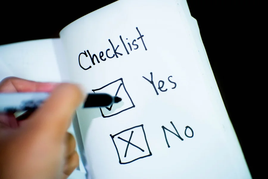 Website Evaluation Checklist A writer using a physical checklist to verify the safety score of a website