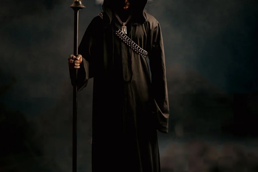 Fantasy wizard character design illustration showing dark magical robes and staff