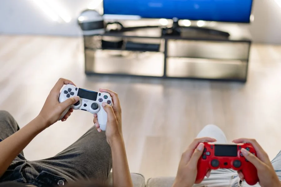 Couch Co-Op Gaming Party friends playing split screen video game couch four controllers