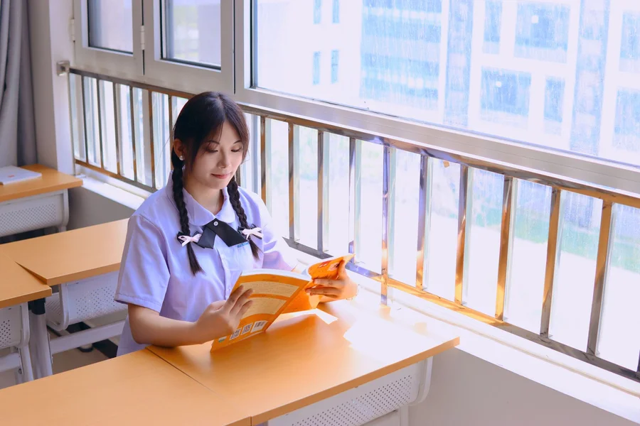 Anime style illustration of teenage student reading manga books in classroom